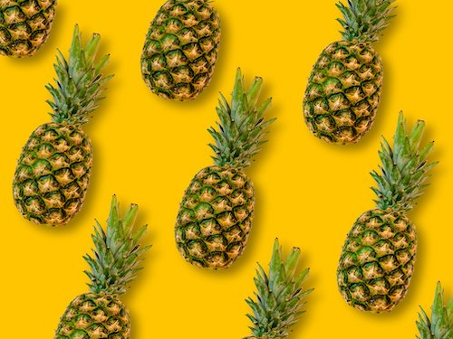 Pineapples on yellow background