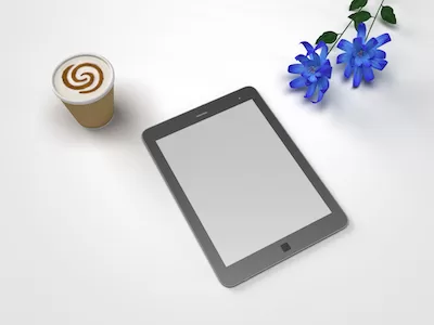 Tablet with cappuccino and flowers