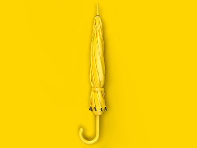 A yellow closed umbrella on yellow background.