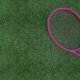 Tennis racket on grass top view - Sports