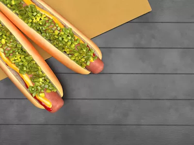 Hotdogs top view on grey wooden background.