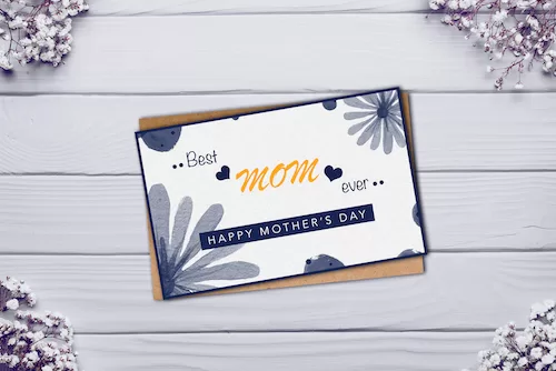 Mothers day card on white wooden background.