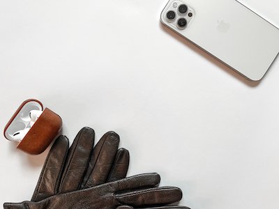 iphone with airpods in opened case and black gloves stock image
