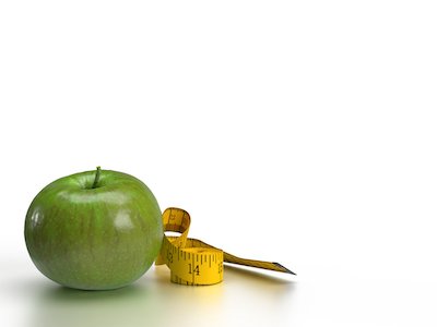 3D Apple with measuring tape on white background.