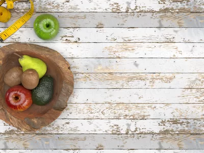 3D Fruits in wooden bowl top view on wooden background.