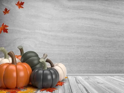 3D pumpkins with leaves on a wooden background.