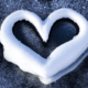 Snow heart - White snow heart stock image.