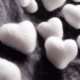 White wool hearts on grey wool - White wool hearts stock photo