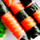 Uncut sushi rolls - Uncut sushi roll with salmon stock image.