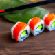 Sushi rolls with leaf - Sushi rolls with chopsticks and leaf stock image.