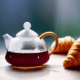 Glass teapot with croissants - Glass teapot with croissants stock image.